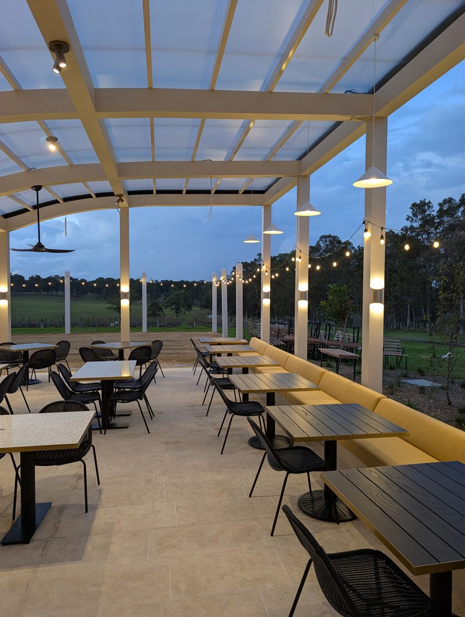 Pergola dining at Iron Gate Estate at dusk — pendants, track spotlights and festoons by NVD Electrical