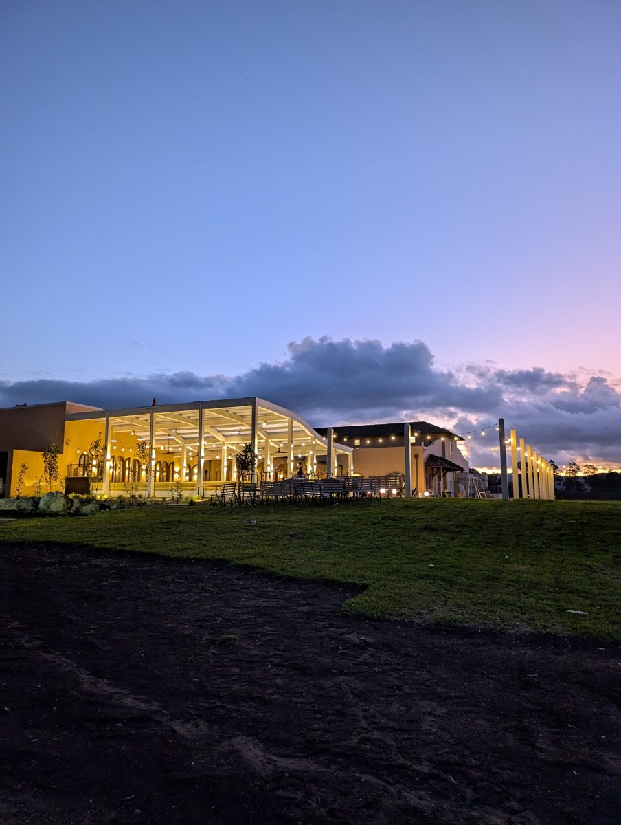 Iron Gate Estate venue exterior at dusk, lighting on